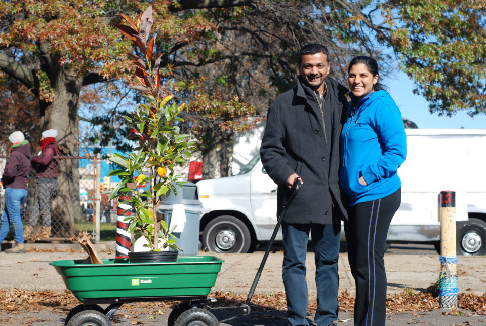 A happy couple takes home a tree at a TreePhilly giveaway event.